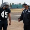Dave Castro Jr. (left), a senior linebacker and offensive lineman for Palo Verde, listens to instruc