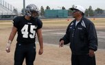 Dave Castro Jr. (left), a senior linebacker and offensive lineman for Palo Verde, listens to instructions from his father, Dave Sr., who is the Panthers' defensive coordinator. Palo Verde faces Las Vegas High in the 4A state semifinals on Saturday.