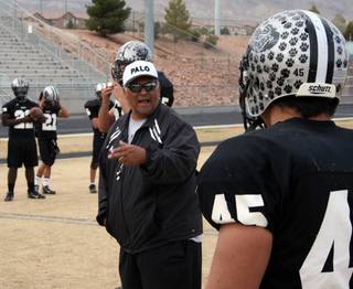Palo Verde senior captain Dave Castro (45) listens to instructions from his father and defensive coordinator Dave Sr. during Tuesday's practice. 