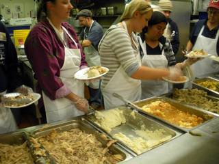 Volunteers load plates with food at the Las Vegas Rescue Mission annual Thanksgiving dinner Wednesday.