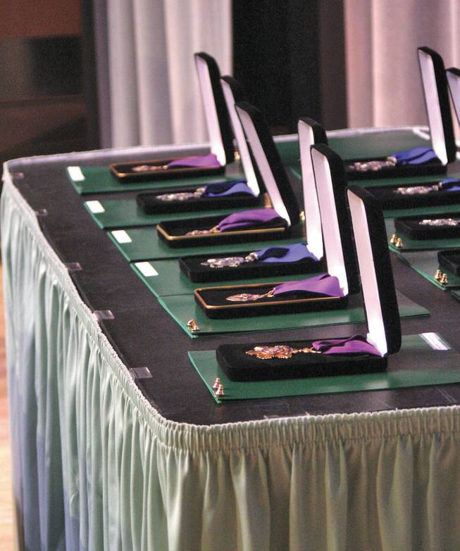 Metro Police Medals of Honor, Medals of Valor and Purple Hearts rest on a table before a commendation ceremony at the West Charleston Library.