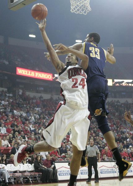 UNLV guard Renee Rougeau tries to get a shot past Cal center Jordan Wilkes during the first half of the game Friday at the Thomas & Mack Center.