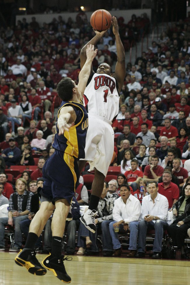 UNLV guard Wink Adams shoots a three over Cal guard Nikola Knezevic during the second half of the game Friday at the Thomas & Mack Center. Cal won the game 73-55. 