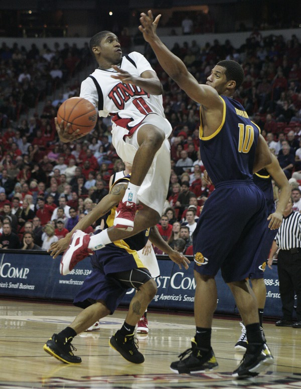 UNLV guard Oscar Bellfield drives past Cal forward Jamal Boykin ...