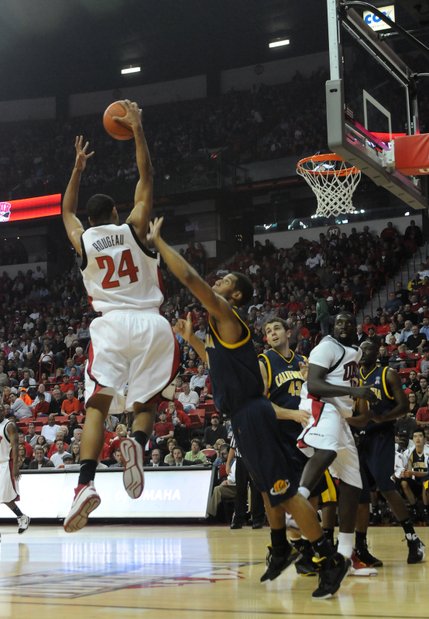 Rene Rougeau of UNLV pulls down a rebound over Jamal Boykin of California Friday at the Thomas & Mack Center.