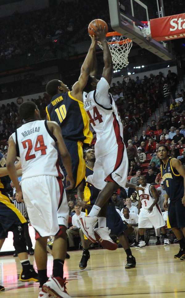 Darris Santee of UNLV puts in a layup over Jamal ...