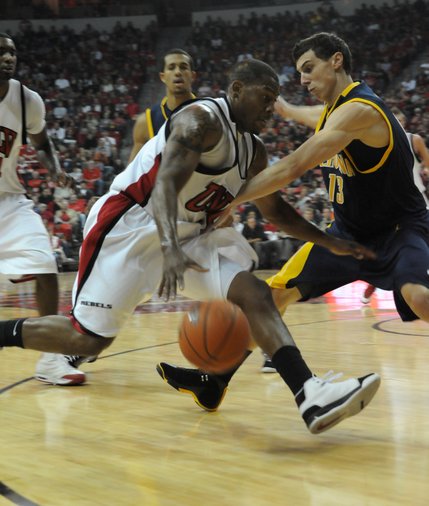 Wink Adams of UNLV drives to the basket against Nikola Knezevic of California Friday at the Thomas & Mack Center.