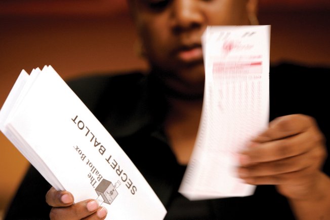 Monya Kegler, an administrative assistant for The Ballot Box, a company hired to conduct the Aliante association election, counts the votes Monday. 