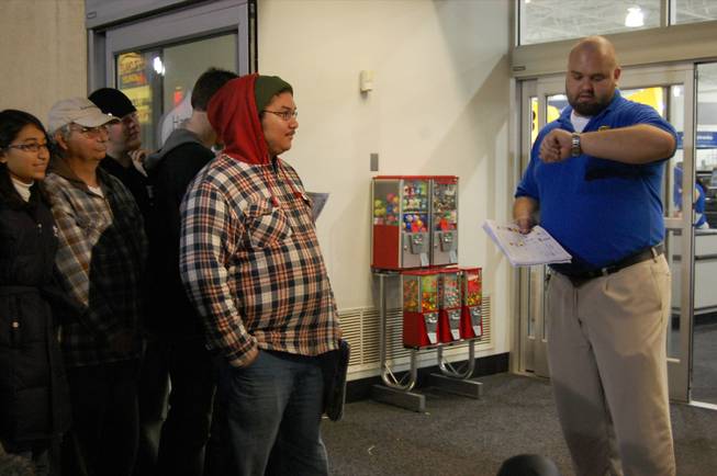 Tim Wheeler, left, waits as General Manager John Ream counts down the final seconds for Best Buy's 5 a.m. opening on Black Friday. Wheeler held his position as first in line at the store since 10 a.m. Wednesday morning. 