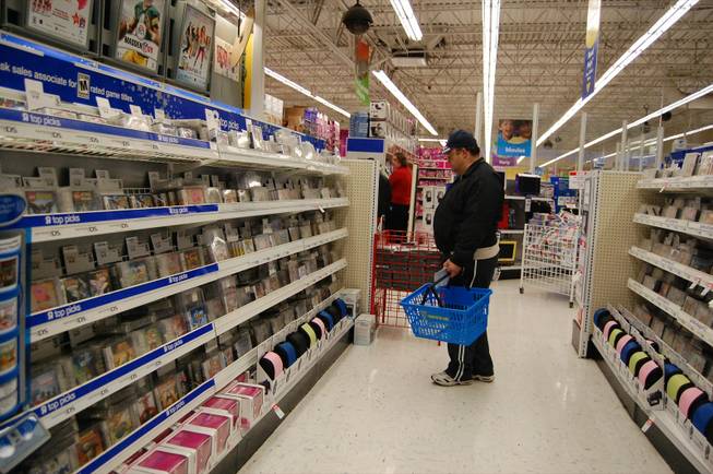 Mark Shockley searches for the perfect Nintendo DS game for his newly adopted 6-year-old daughter at Toys "R" Us Friday. 