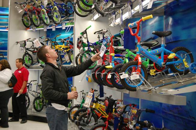 Paul Davidson looks at bikes for his 2-year-old son at Toys "R" Us Friday. Davidson was the first in line for the midnight opening. 
