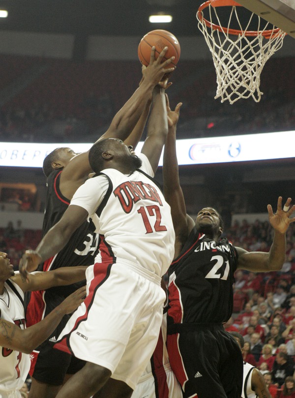UNLV forward Brice Massamba battles Cincinnati forwards Yancy Gates, left, ...