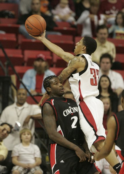 UNLV guard Tre'Von Willis shoots over the top of Cincinnati guard Eddie Tyree during the first half of the game Saturday at the Thomas & Mack Center. 