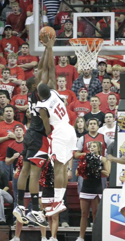 DeShawn Mitchell of UNLV blocks Yancy Gates of Cincinnati Saturday at the Thomas & Mack Center.