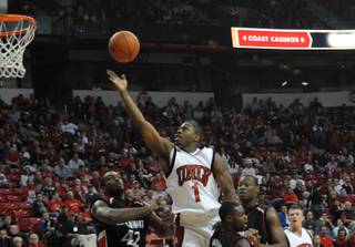 Wink Adams lays it up and over the Cincinnati defense Saturday at the Thomas & Mack Center.