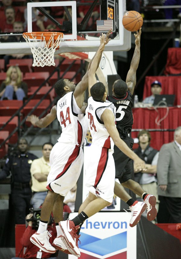 Darris Santee and Rene Rougeau contest Deonta Vaughn of Cincinnati ...
