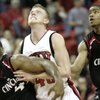 Joe Darger of UNLV fights for position against Steve Toyloy (left) and Dion Dixon of Cincinnati Saturday at the Thomas & Mack Center.