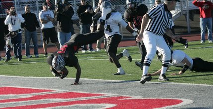 Las Vegas; Reggie Bullock (5) hurdles in for a touchdown during the Nevada State semifinals football game against Palo Verde Saturday.