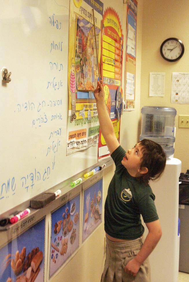 Hailey Rodis takes her turn at the daily exercise of reading the calendar day in Hebrew at Solomon Schechter Day School on Nov. 26.  Solomon Schechter is partnering with Alexander Dawson to provide Hebrew as one of its language courses.
