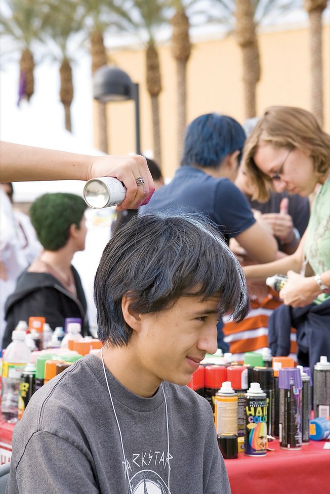 Dayne Miller, center, awaits the completion of his new hair color at H.O.P.E. for the Holidays. The Nov. 22 event at the Henderson Pavilion featured a silent auction to benefit Homeless Outreach Partnership Event, which offers assistance to Southern Nevada's homeless.