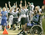 Green Valley senior linebacker LaQuan Phillips, who was temporarily paralyzed on Sept. 5 during a game against Centennial, is seen here cheering on his teammates during the Henderson Bowl on Oct. 30. Phillips returned to class at Green Valley High Monday.