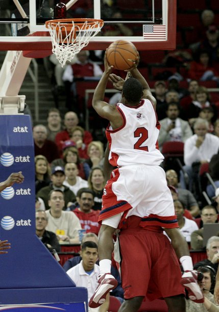 Brice Massamba of UNLV draws a charge from Bryce Cartwright of Fresno State at the Save Mart Center in Fresno, Calif.
