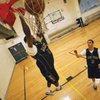 Lake Mead Christian Academy guard Dequan Thompson, left, dunks an alley-oop from teammate Landon Littlefied.