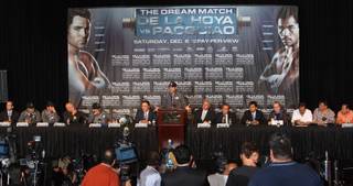 Boxer Oscar De La Hoya, center, speaks during a news conference at the MGM Grand on Wednesday, December 3, 2008. De La Hoya and Manny Pacquiao will meet in a 12-round welterweight fight at the MGM Grand Garden Arena on Saturday.