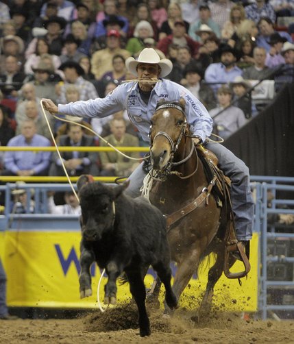 Stran Smith, of Childress, Texas, competes during the first go-round of tie-down roping at the National Finals Rodeo at the Thomas & Mack Center in Las Vegas, Thursday, Dec. 4, 2008. (AP Photo/Jae C. Hong)
