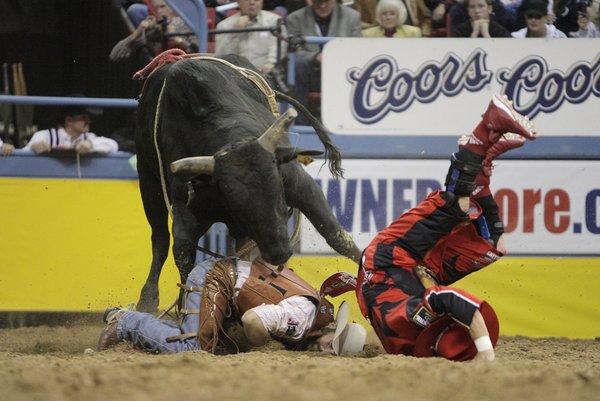 Rodeo clown, bottom right, and bull rider Cody Hancock, of ...