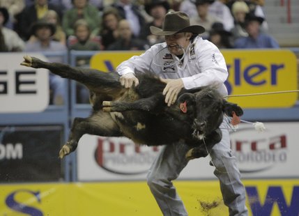 Tuf Cooper, of Decatur, Texas, competes during the first go-round of tie-down roping at the National Finals Rodeo at the Thomas & Mack Center in Las Vegas, Thursday, Dec. 4, 2008. (AP Photo/Jae C. Hong)