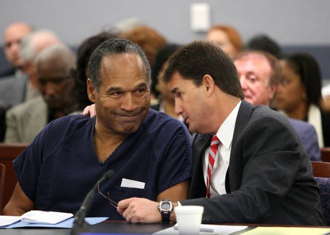 O.J. Simpson, left, listens to his attorney Yale Galanter during his sentencing hearing at the Clark County Regional Justice Center in Las Vegas Friday, Dec. 5, 2008.