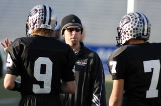 Palo Verde assistant coach Brian Cox talks to quarterback Kelly Zurowski (9) and fullback Grant Bernhardy (7)  during practice Friday afternoon at Mackay Stadium in Reno, Nev. Palo Verde will face McQueen High School in the 4A high school championship game Saturday. 