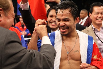 Manny Pacquiao bumps fist with boxing promoter Bob Arum after defeating Oscar De La Hoya at the MGM Grand Garden Arena Saturday night.