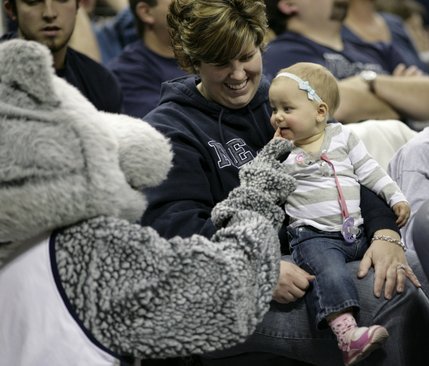 The UNR mascot plays with a baby in the crowd Saturday at the Lawlor Events Center in Reno.  UNLV defeated UNR 64-57.