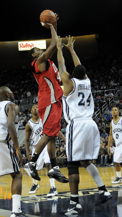 Darris Santee of UNLV shoots over the top of the UNR defense Saturday at the Lawlor Events Center in Reno.  UNLV defeated UNR 64-57.