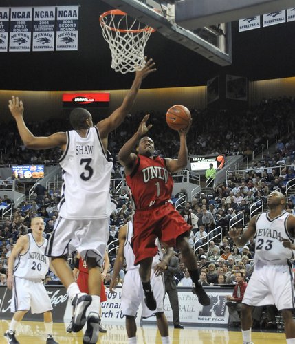 Wink Adams lays it up over Joey Shaw of UNR Saturday at the Lawlor Events Center in Reno.  UNLV defeated UNR 64-57. 