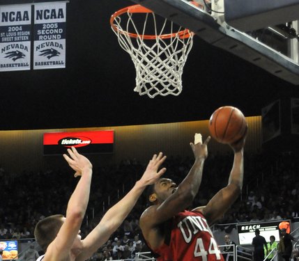 Darris Santee lays it in over Luke Babbit of UNR Saturday at the Lawlor Events Center in Reno.  UNLV defeated UNR 64-57.