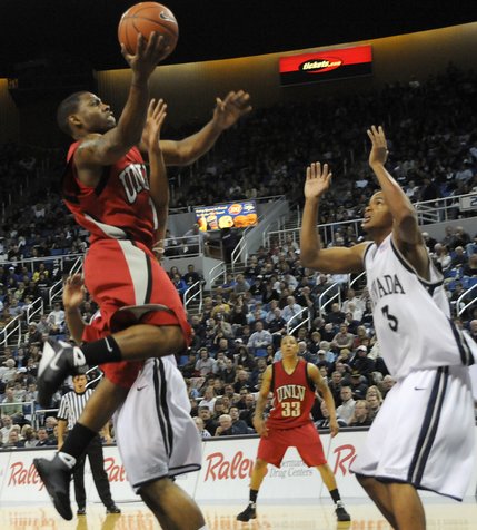 Wink Adams lays it up over the defense of UNR Saturday at the Lawlor Events Center in Reno.  UNLV defeated UNR 64-57. 