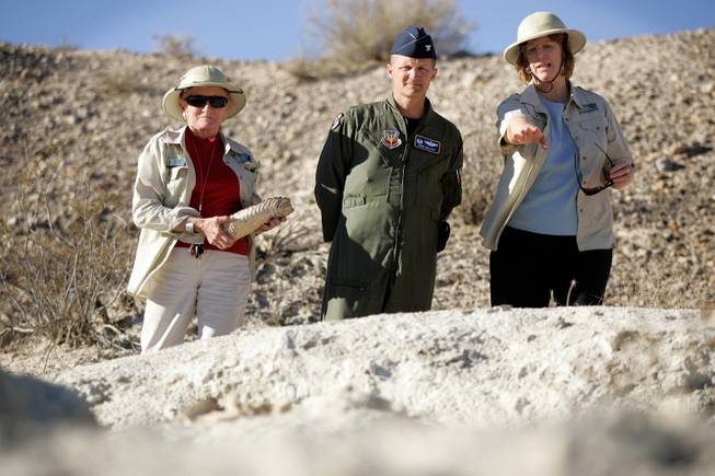 Helen Mortenson, left, holding a mammoth tooth; Jill DeStefano, founder of the Protectors of Tule Springs; and Col. Howard Belote of Nellis Air Force Base tour the Upper Las Vegas Wash in November.