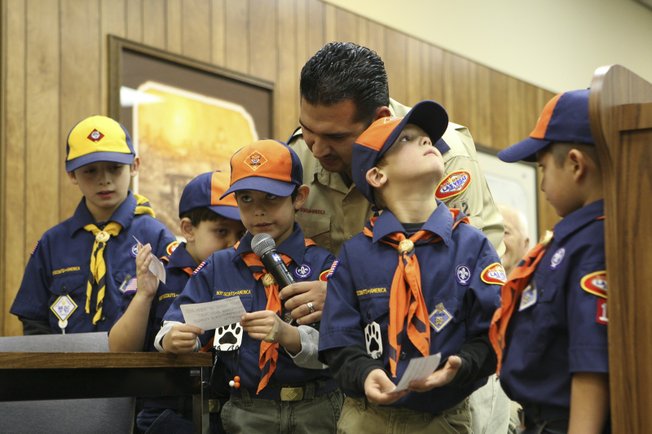 First-grader Dylan Mullins reads suggestions to the City Council to increase public safety by replacing missing fire hydrant markers during the Council Meeting Tuesday. From left: Ryan Brown, 7; Devon Kelman, 6; Dylan Mullins, 6; leader Don Rodriguez; Thomas Brown, 6; and Luke Rodriguez, 6.