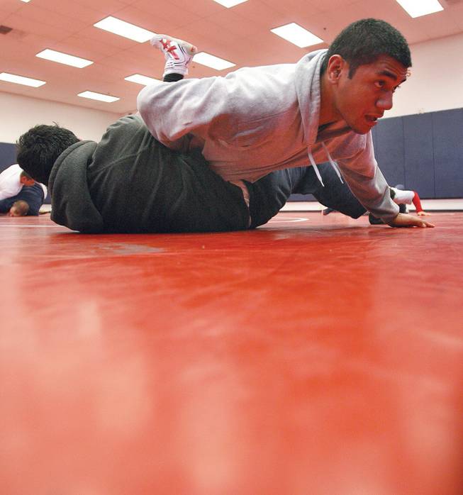 Liberty wrestlers Carlos Tautoto, top, wrestles against Alberto Lopez during practice.