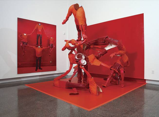 The multimedia installation "Cheerleaders," by Katie Grinnan, includes the wall-size depiction of headless, hollow-cast figures, which are taken apart and mounted using plastic, linoleum and various paints.