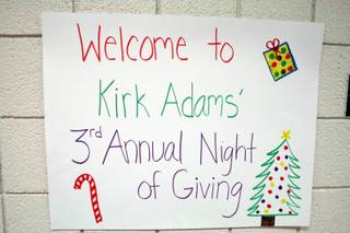 A handmade sign advertising Kirk L. Adams Elementary school's Night of Giving Wednesday.