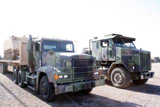 Two of the trucks used for training by the Nevada Army Guard's 1864th Transportation Company, which will be deployed to Iraq and Kuwait in April. Both the 915 truck, left, and the Heavy Equipment Transport truck are used to move supplies and equipment from Kuwait to Iraq. The HET truck here has already been used in Iraq.