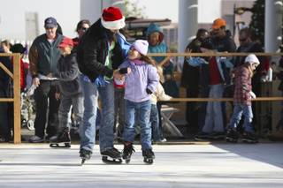 Justice Rodriguez, 8, looks for skating advice from her older sister Jazmynn Rodriguez, 16, at the ice rink Saturday during the 2008 WinterFest.