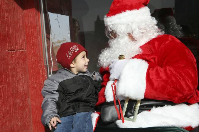 While sitting on Santa Claus' knee at WinterFest, Daniel Stabolito, 3, asks for Wall-E the robot during the 2008 WinterFest Saturday at the Henderson Events Plaza.