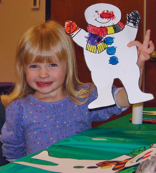 Lauren Poulios, 3, shows off her snowman at the "Shoes for Snowmen" event at the Summerlin Library on Dec. 1.
                               