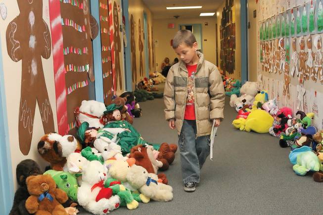 While walking through the hallways at Edna F. Hinman Elementary School, Austin Martin, 6, admires the 450 stuffed animals he and his classmates collected to give to children in need or in the hospital as part of the school's stuffed animal drive.