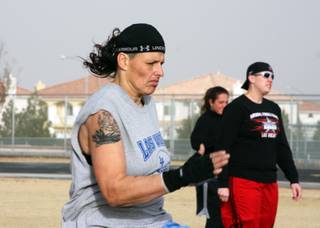 A Las Vegas Showgirlz teammate practices running drills at the women's tackle football team tryouts Saturday.